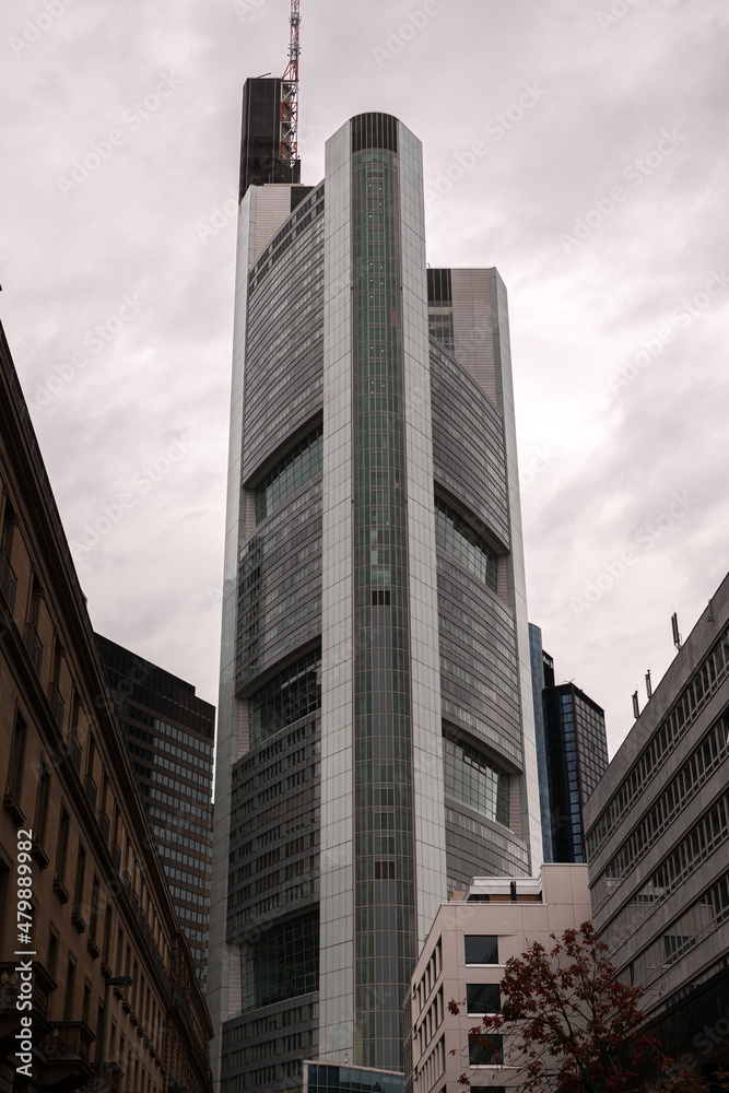 Financial district of Europe in Frankfurt, Germany. Tall skyscraper office buildings photographed in a cloudy day. Business and finance industries.