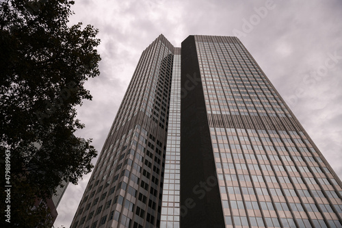 Financial district of Europe in Frankfurt, Germany. Tall skyscraper office buildings photographed in a cloudy day. Business and finance industries.