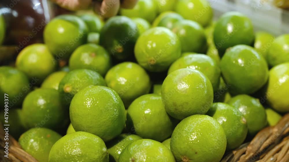 Feale hand selecting fresh limes at the supermarket 4k Feale hand selecting fresh limes at the supermarket 4k