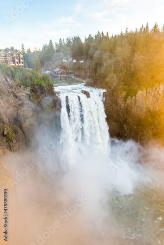 snowqualmie fall at sunset with a lot of fog.