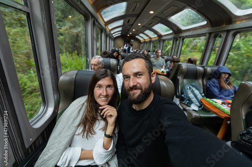 A young couple takes a selfie at the train, Cusco, Peru
