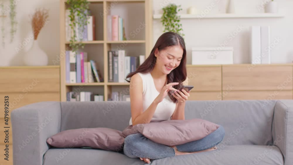 Happiness Entrepreneur beautiful business asian young woman wear casual use mobile phone for shopping online laughing enjoy with social media and laptop at home.Small Business Startup.online banking