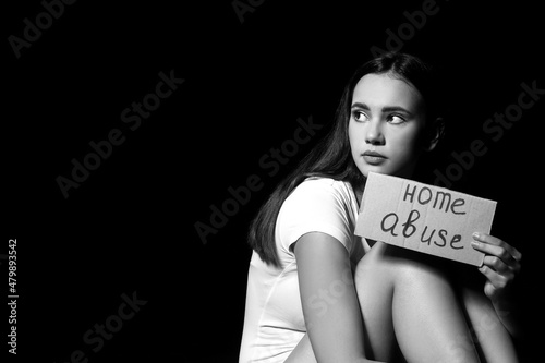 Scared woman holding paper ...
