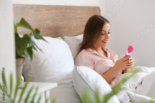 Young woman with vibrator i...