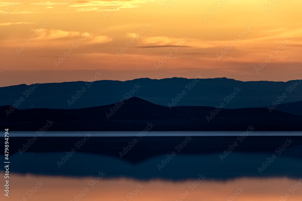 Salt lake and azure mountains at sunset