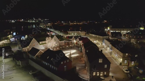 Buildings By The Bank Of Olfusa River Near Olfusarbru Bridge In Selfoss, Iceland During Nighttime. aerial pullback photo