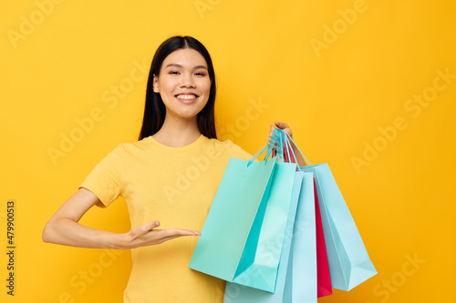 pretty brunette with packages in hands shopping isolated background unaltered