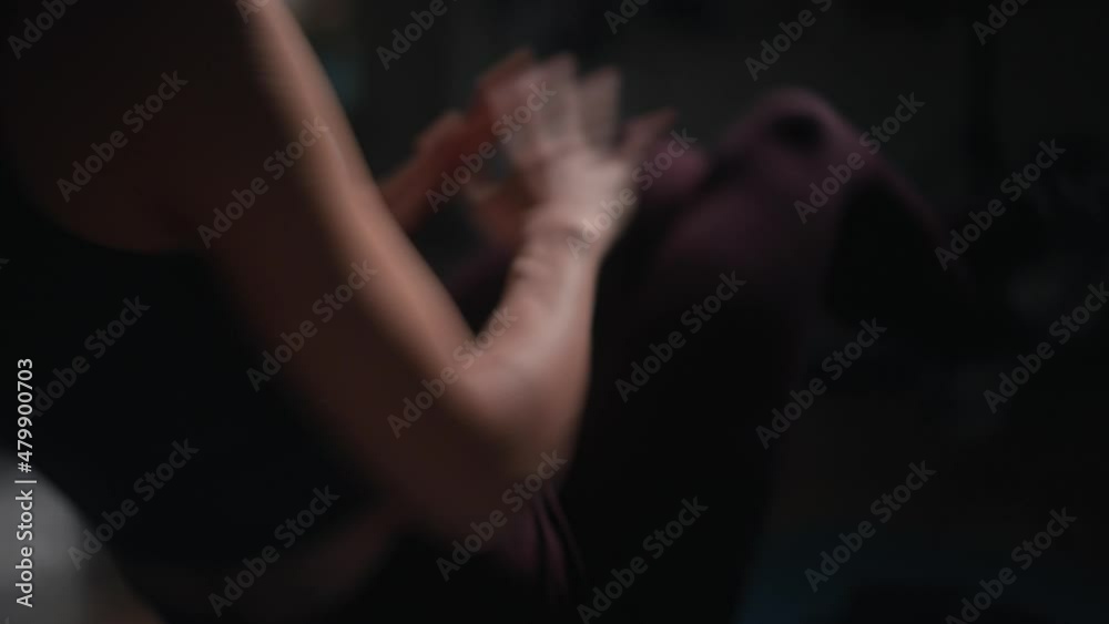 Closeup of focused girl working out in spotlight, slow motion Closeup of focused girl working out in spotlight, slow motion