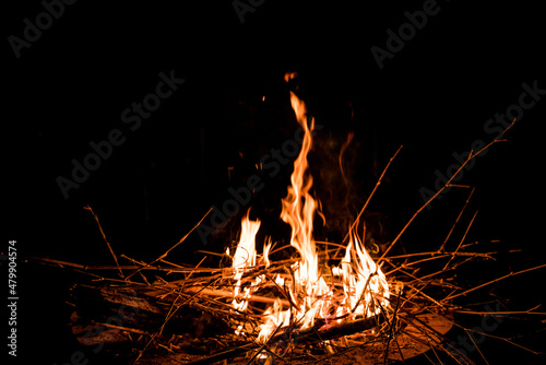 fire and flames. Flames and burning sparks close up, fire patterns. flames from the fire. Night bonfire, logs are on fire, sparks fly. soft focus.shallow focus effect..