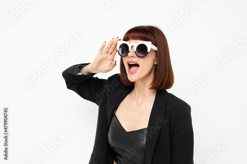 photo pretty woman posing with sunglasses a leather suit black jacket Lifestyle unaltered