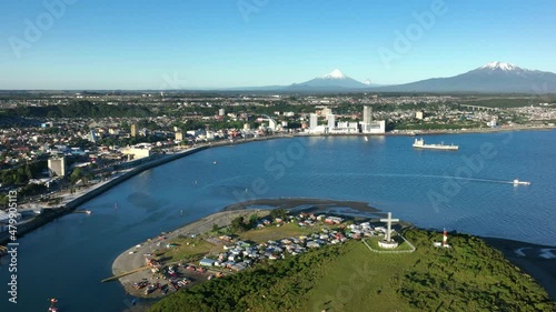 Aerial Over Tenglo Island With Bay Of Puerto Montt With Calbuco Volcano Seen In Distant Background. Dolly Right photo