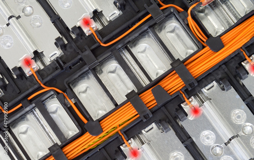 Selective focus of Electric car lithium battery pack and wiring connections internal between cells on background.	