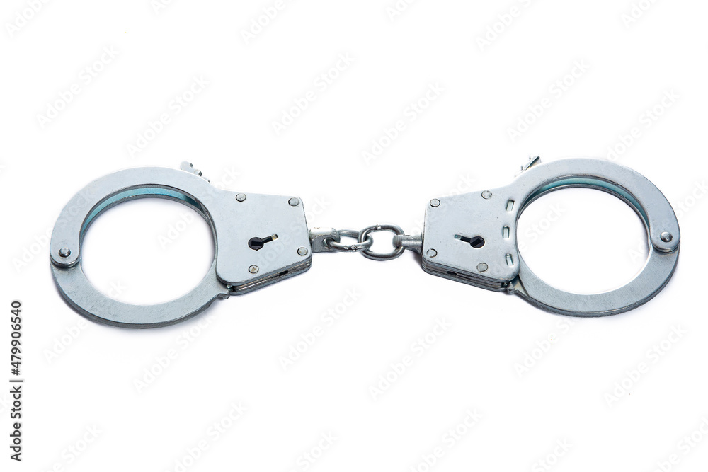 Metal handcuffs on a white isolated background