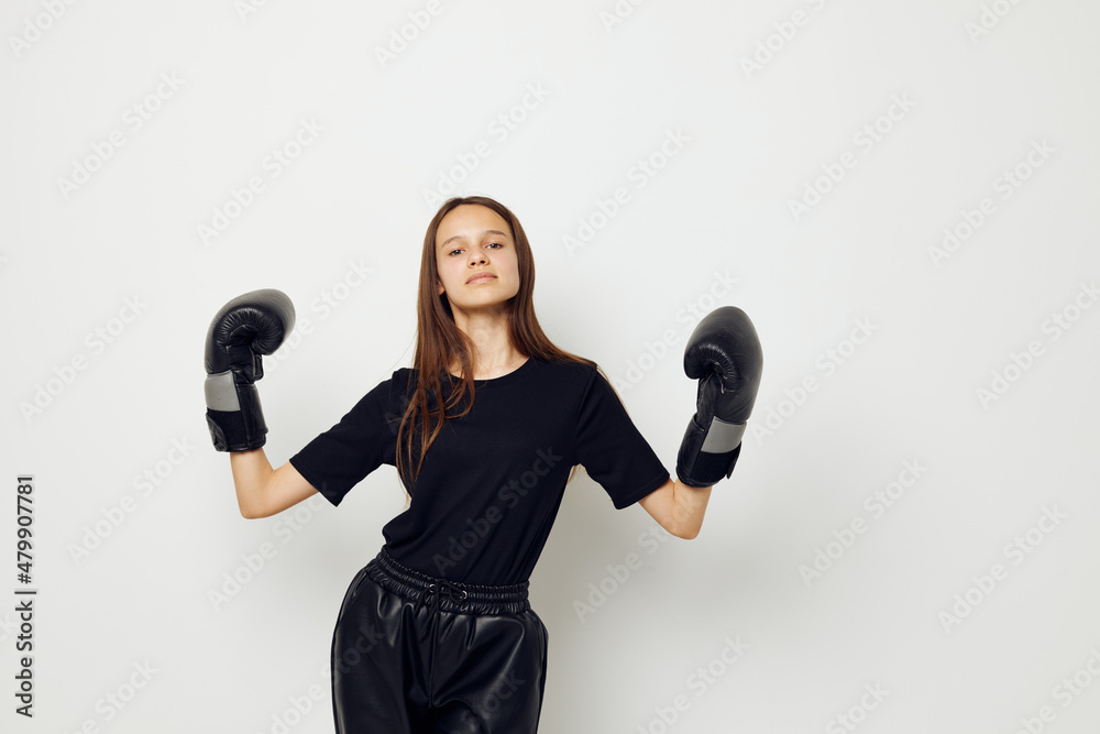 young beautiful woman in black sports uniform boxing gloves posing isolated background young beautiful woman in black sports uniform boxing gloves posing isolated background