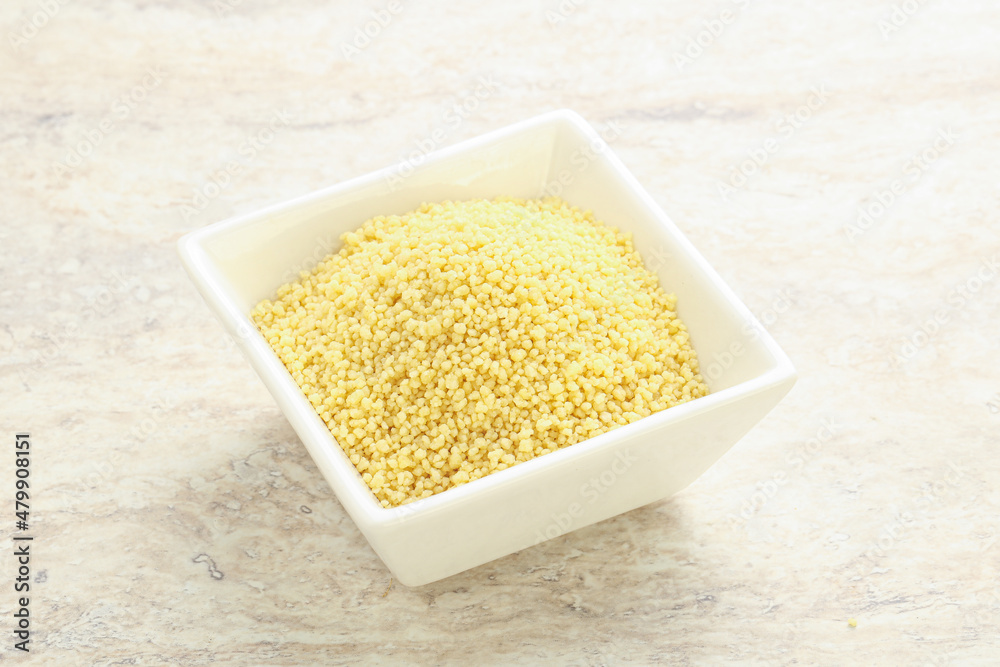 Raw couscous in the bowl Raw couscous in the bowl