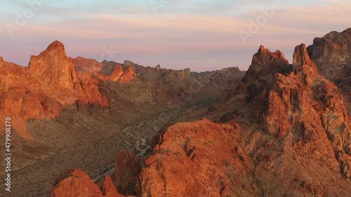 Drone view at sunset over jagged red rock formations in the Arizona desert near kofa nature preserve. photo