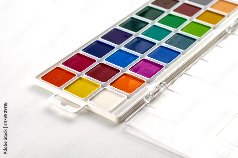 a box with watercolor paints on a white background close-up a box with watercolor paints on a white background close-up