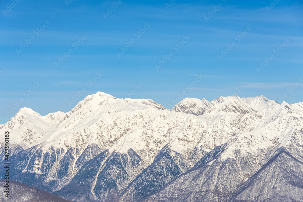 Mountain range pass with snow-capped peaks in winter. Mountain range pass with snow-capped peaks in winter.