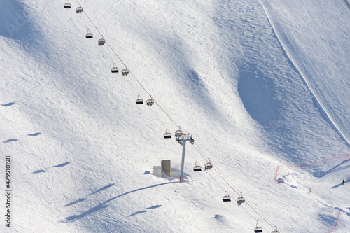 Ski lifts snowy slope for skiing winter.