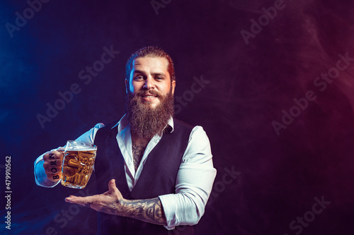 Happy bearded man holds tasty draft beer in hand while gesturing. Drinking, October fest concept. 