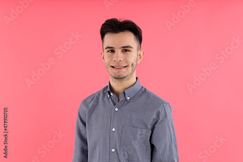 Attractive guy in shirt on pink background