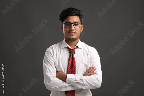Young indian man showing expression on dark background.