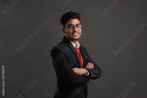 Young indian business man showing expression on dark background.