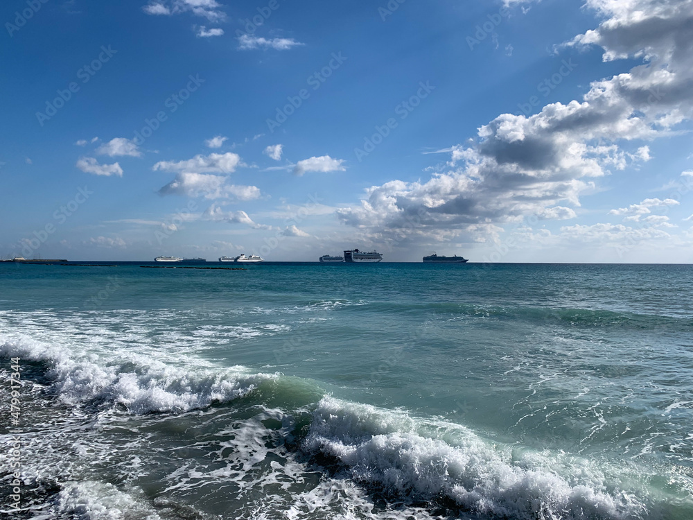 Silhouettes of the ships on the sea horizon