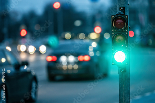 traffic light on the street junction with beautiful bokeh, city with cars in the background