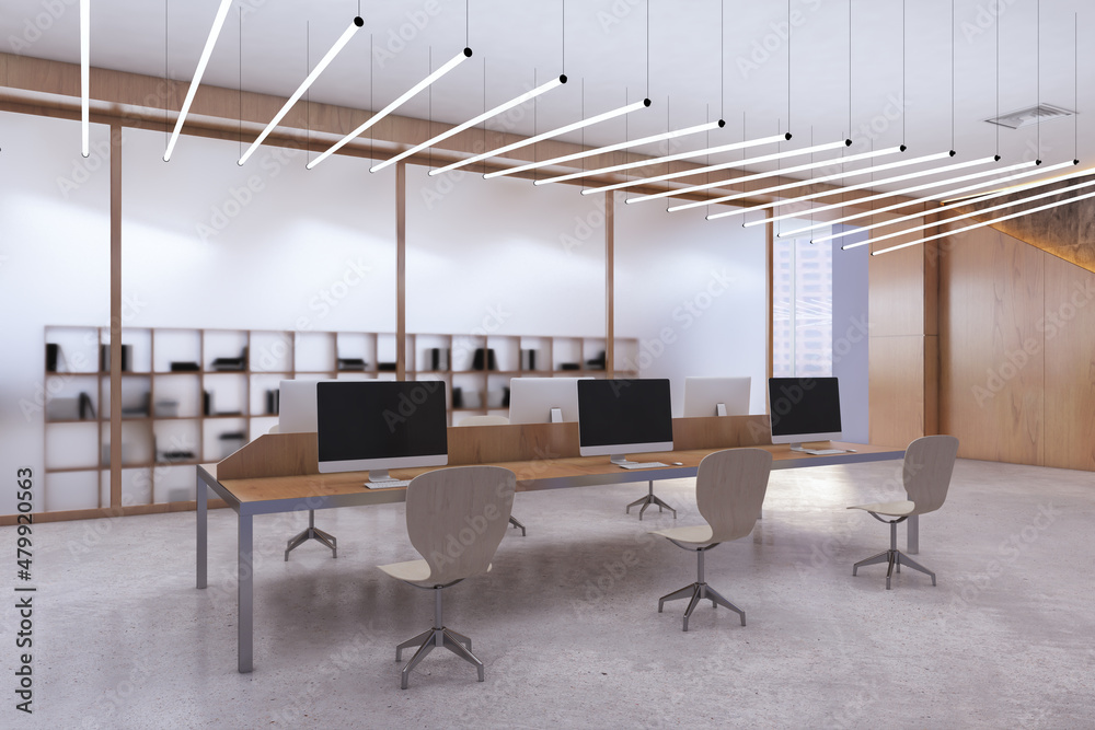 Luxury concrete and wooden coworking office interior with window and city view, empty computer screens, equipment, furniture and daylight. 3D Rendering.