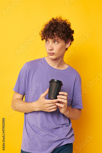 guy with curly hair disposable black glasses yellow background