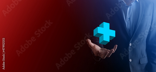 Businessman hold 3D plus icon, man hold in hand offer positive thing such as profit, benefits, development, CSR represented by plus sign.The hand shows the plus sign