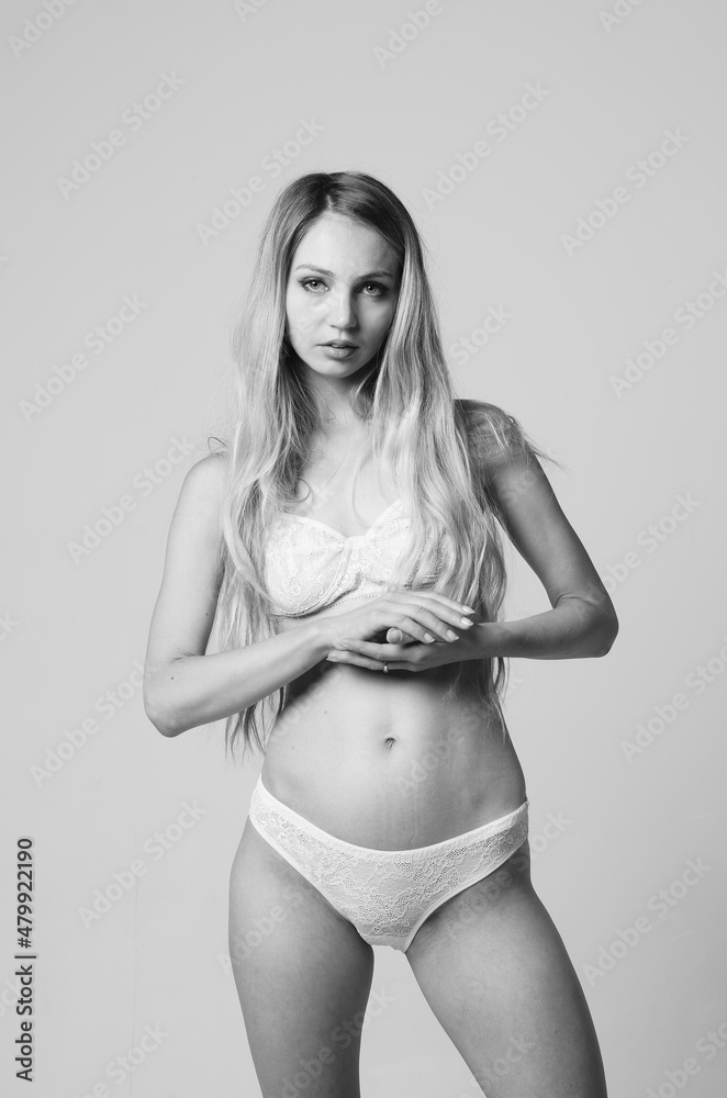 Naklejka premium portrait of exquisite woman in lingerie sitting.