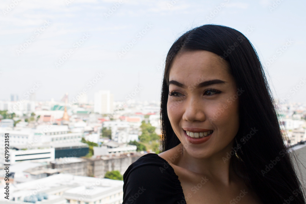 Young asian woman smiling happy on the city background