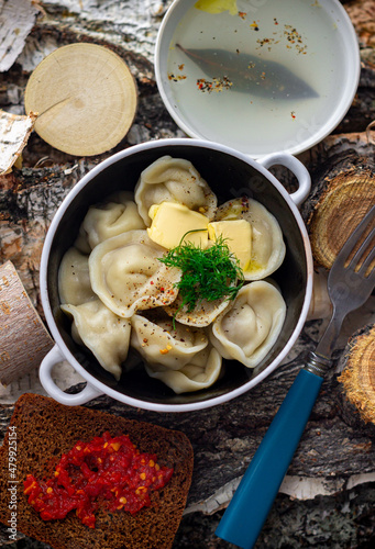Russia traditional dish Siberian dumplings on a wooden background