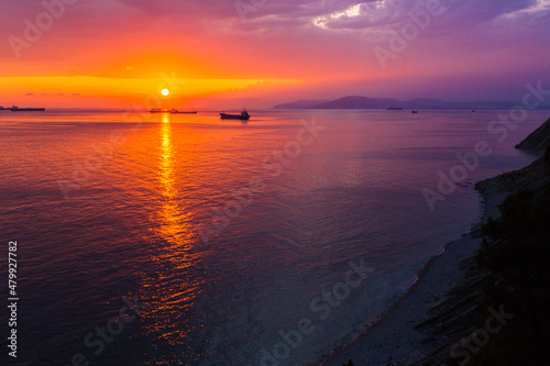 bright, colorful sunset over the sea, blue sky, rich cloud