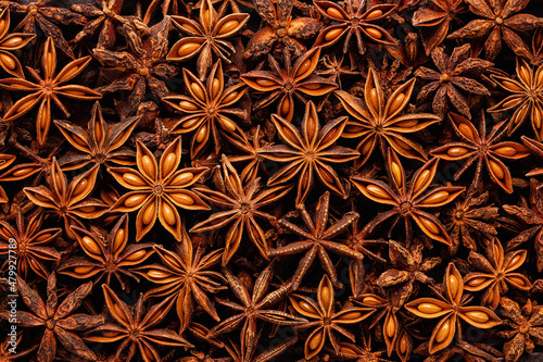 Star anise seeds, full frame. Star anise is used as an aromatic spice in cooking and Chinese cuisine.