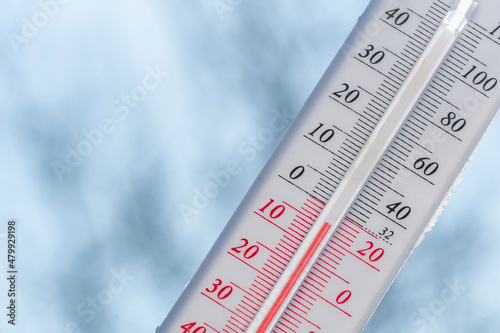 Thermometer in winter in the cold on snow and analyzes low negative air temperatures in clear sunny weather.Meteorological conditions and environmental analysis.Climate change on earth.Northern region
