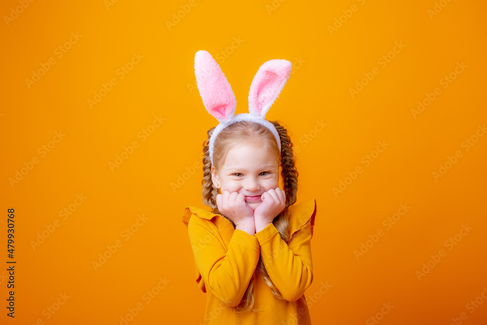 cute little girl with Easter bunny ears,on a yellow background, shows different emotions, joy, surprise, happiness, dreaming, cute little girl with Easter bunny ears,on a yellow background, shows different emotions, joy, surprise, happiness, dreaming,
