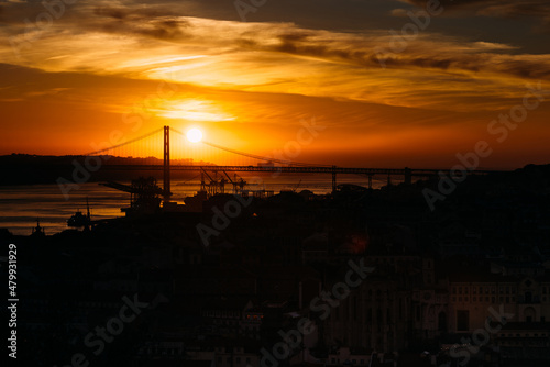 Sunset overlooking Lisbon's Baixa and 25 April Bridge on the Tagus River, Portugal