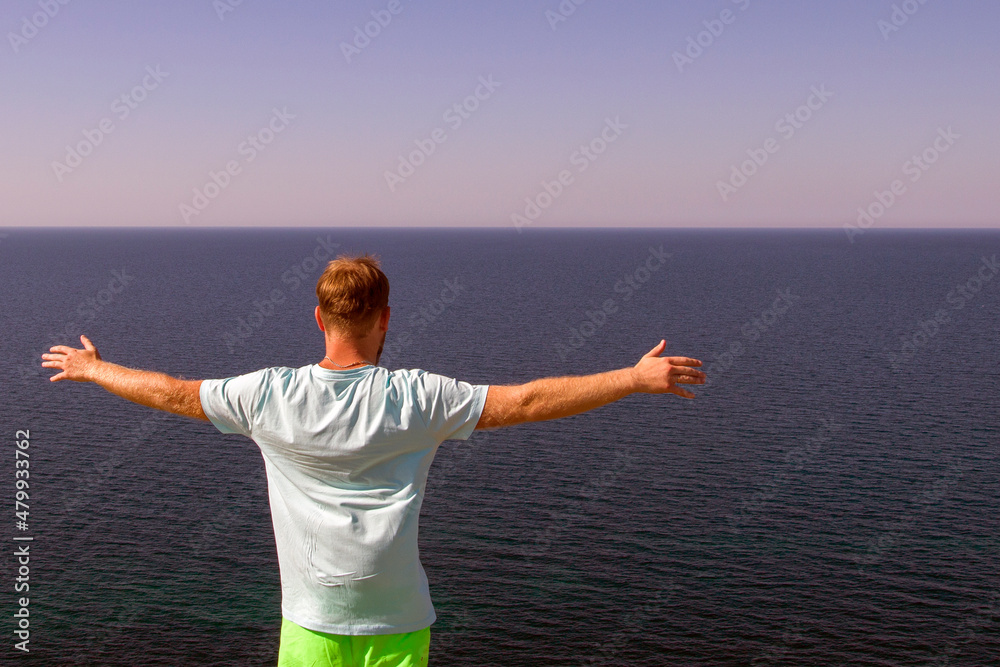 happy man enjoying freedom with open hands on the sea happy man enjoying freedom with open hands on the sea