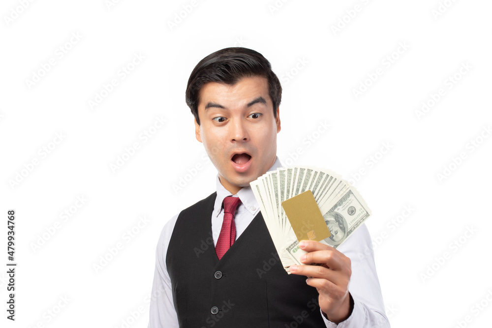 Handsome business man in black suit holding credit card and money isolated on white background. Business, technology, ecommerce and online payment concept. Handsome business man in black suit holding credit card and money isolated on white background. Business, technology, ecommerce and online payment concept.