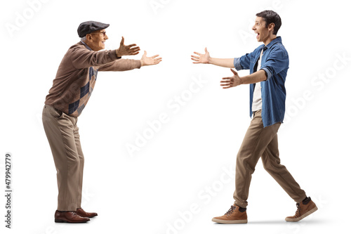 Full length profile shot of an elderly and young man walking towards each other for embrace