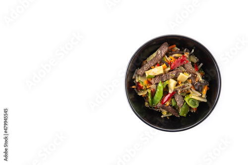 Beef  vegetables and sesame seeds in black bowl isolated on white background. Top view. Copy space