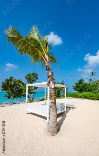white bed on the sandy beach of the sea