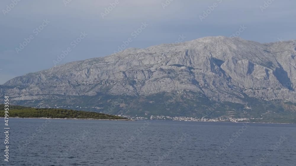 View of mountain Biokovo and Makarska riviera from moving tourist ship in Adriatic sea View of mountain Biokovo and Makarska riviera from moving tourist ship in Adriatic sea