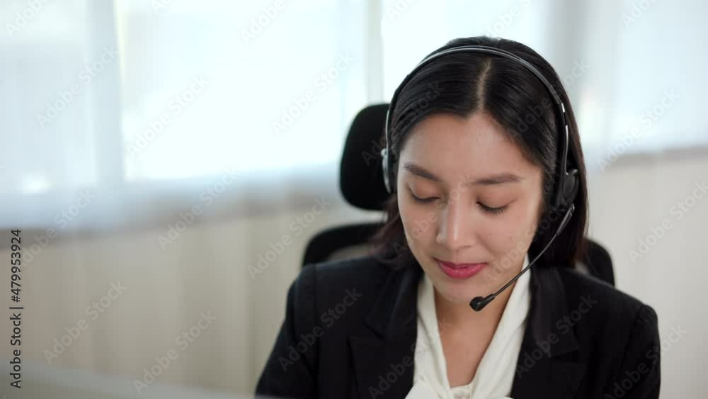 Smiley asian business woman receptionist wear headphone video conference calling on computer talk by webcam in online chat, customer support service. Smiley asian business woman receptionist wear headphone video conference calling on computer talk by webcam in online chat, customer support service.