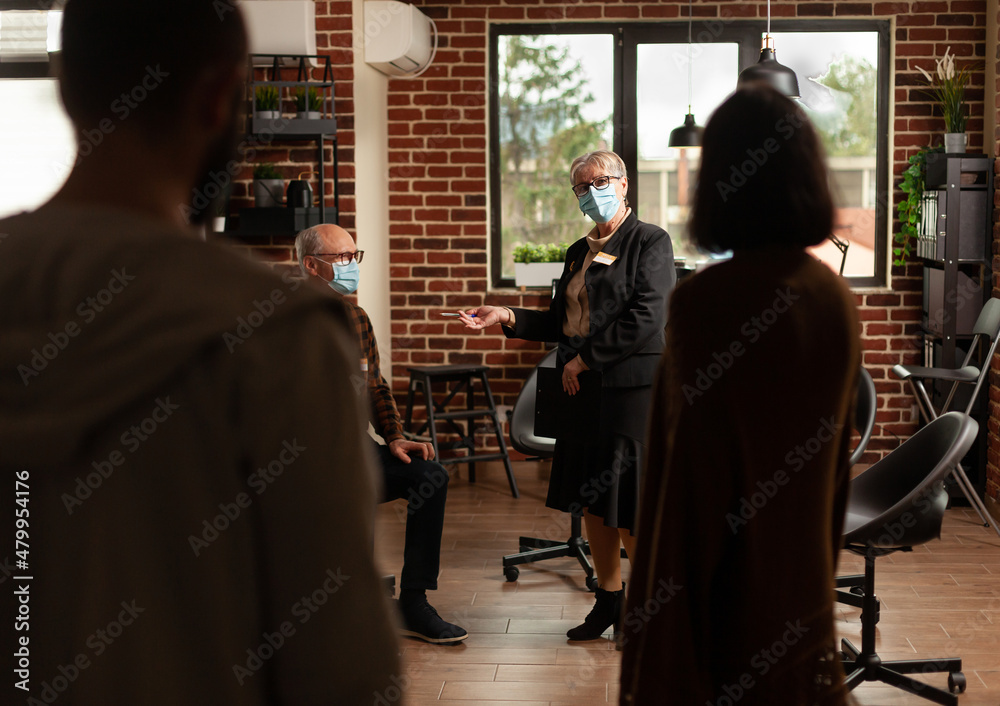 People at aa group meeting standing in office to do mental health exercise with therapist. Patients attending therapy session program to receive counseling from psychotherapist during pandemic. People at aa group meeting standing in office to do mental health exercise with therapist. Patients attending therapy session program to receive counseling from psychotherapist during pandemic.