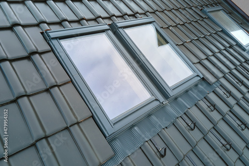 Bilde på lerret Closeup of attic window on house roof top covered with ceramic shingles