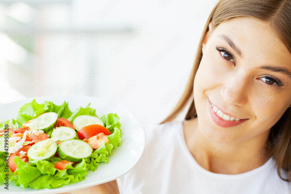 Young woman hold healthy salad with green fresh ingredients Young woman hold healthy salad with green fresh ingredients